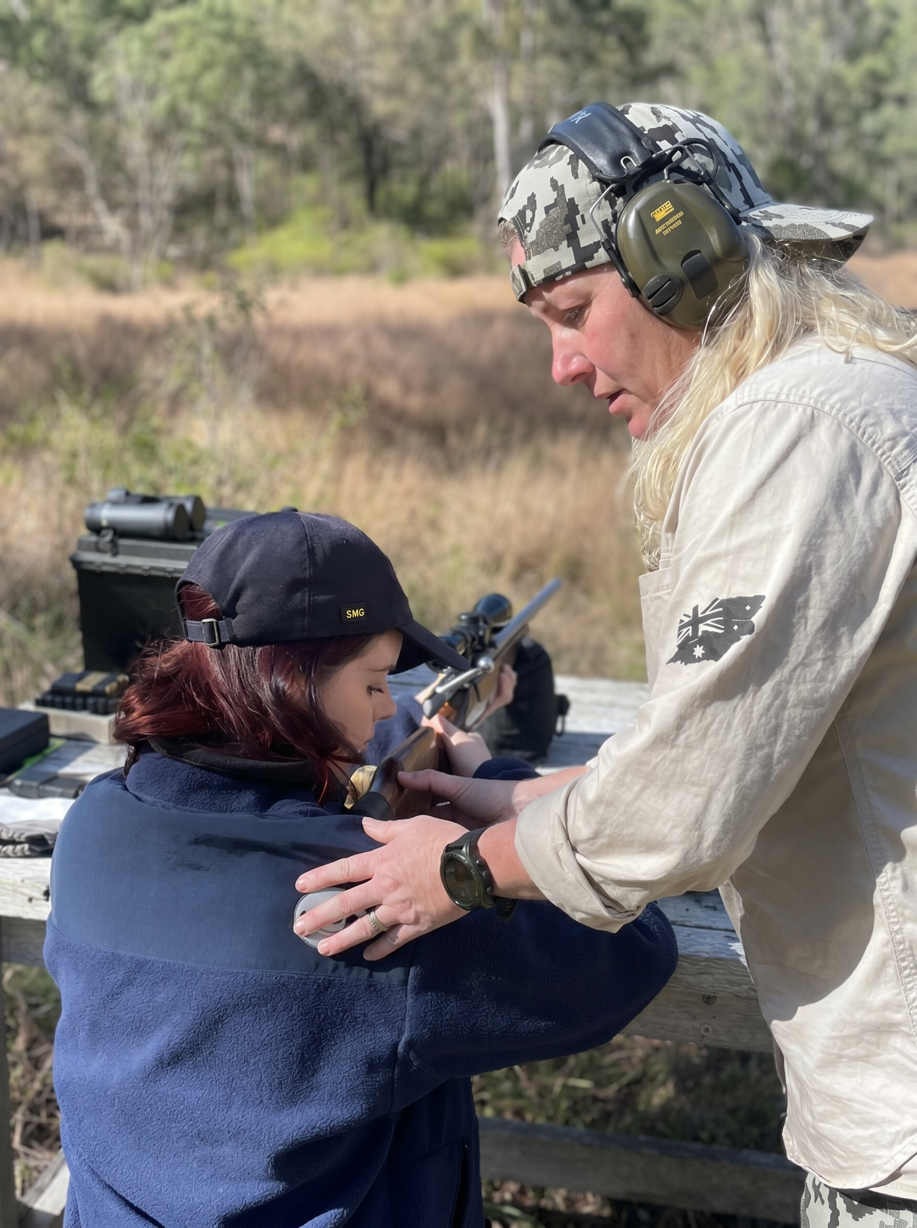 Women Who Hunt coach teaching a beginner how to shoulder a rifle in the correct position