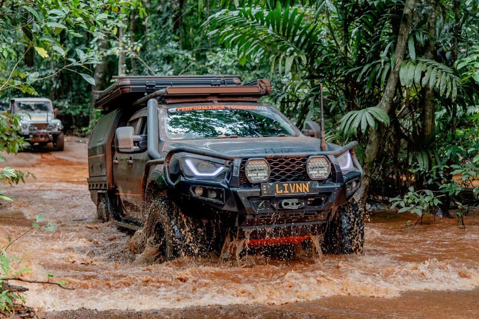 Liv driving through a river crossing in Cape York jungle